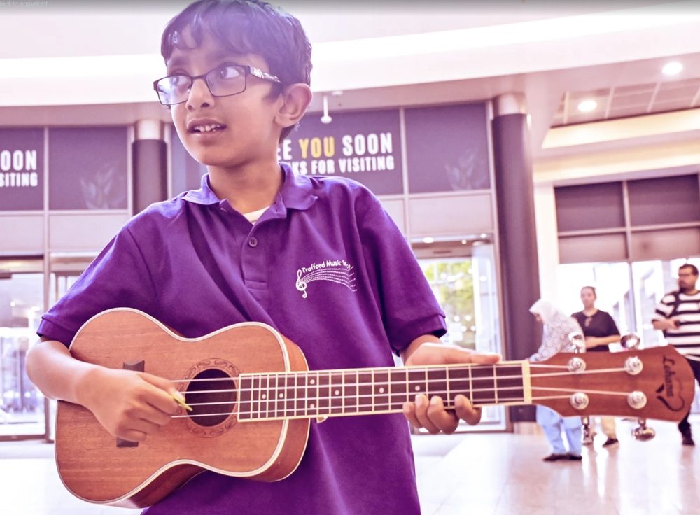 Markandeyulu Kode's son playing the ukulele